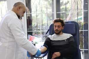 Students and staff participating in a blood donation campaign on the USAL University campus in Lebanon to support public health and save lives.